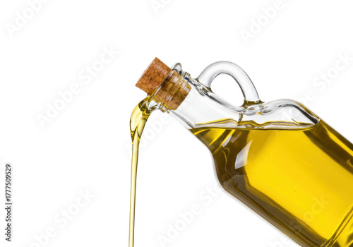 Isolated Extra Virgin Olive Oil pouring from a glass bottle against a clean background