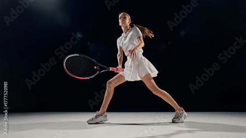 Fotografija Female tennis player standing wide stance ready position indoor arena light