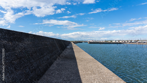 Long Concrete Breakwater under Clear Blue Sky