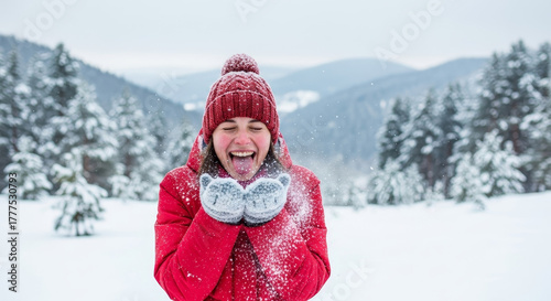 Joyful woman catching snowflakes on her tongue in a snowy winter forest, experiencing pure winter bliss.
