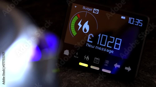 British Gas and electric digital meter reading with kettle with blue light in foregound 