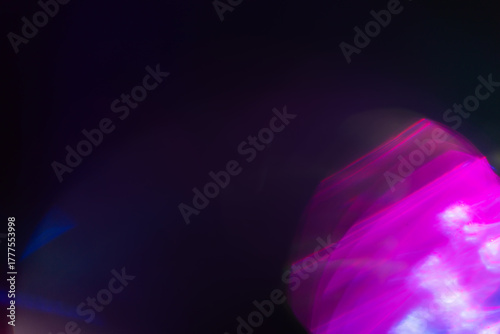 Colorful light leak on black background, abstract design with optical lens flare shot on a long lens