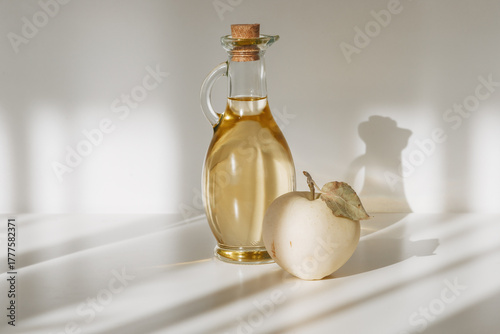 Fresh ripe apples and apple cider vinegar. White background. Light background.