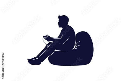 Silhouette of a gamer relaxing on a bean bag chair playing video games