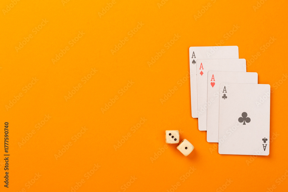 Obraz premium Poker chips and playing cards on color background, top view. Casino card game