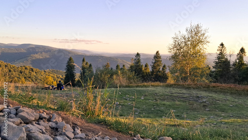 Fototapeta Naklejka Na Ścianę i Meble -  Biker relaxing on a meadow in Beskids.