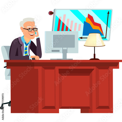 Elderly Man In Suit And Tie Talking On Phone In Office Sitting At Desk With Computer And Lamp And Financial Graph On Screen