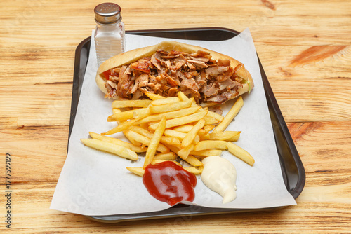 Obraz na plátne Sandwich kebab sur un plateau avec frites et sauces – restauration rapide turque