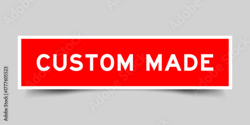 Red color square shape sticker label with word custom made on gray background