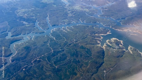 An aerial shot of a green hilly terrain 