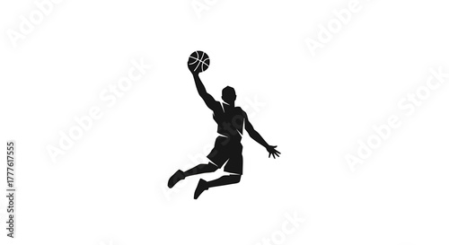 Silhouette of a basketball player leaping in the air, reaching for the hoop with the ball during a game