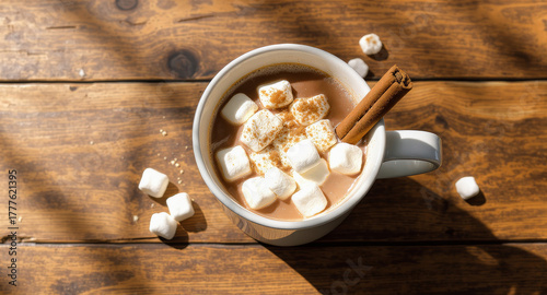 Warm comforting hot chocolate topped with fluffy marshmallows and a cinnamon stick, perfect for cozy winter days and holiday cheer.