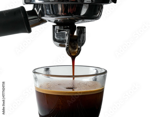 Dark, rich espresso dripping into a clear glass, close up