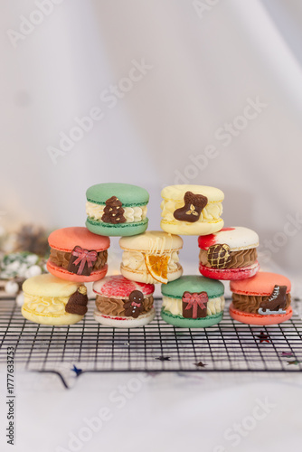 macaron dessert for christmas. homemade unique cookie. bow and sprinkles. various colors. present box. white