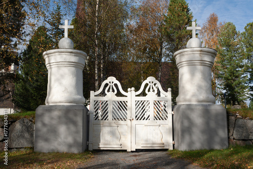 White gate and pillars decorated with cross-symbols