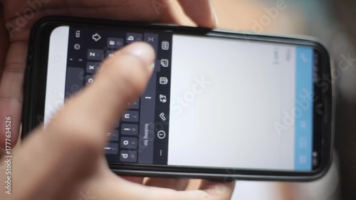Human hand holding smartphone and typing with thumb showing Generation X mobile behavior, steady texting motion, familiar keypad habit and natural digital communication in daily phone usage footage