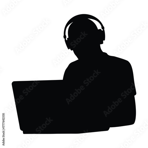Silhouette of Person with Headphones Working on Laptop or Remote Studying