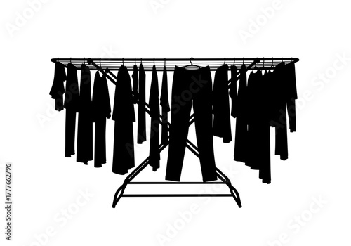 Clothes drying rack with black garments hanging indoors  