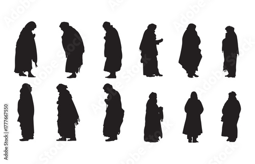 Silhouette of an old woman warming herself in the winter