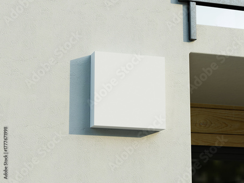 Simple box sign mockup on a gray wall with soft shadowing effect.