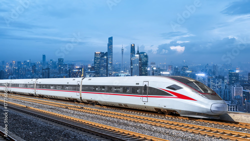 Fotografie Modern high - speed train running through urban area