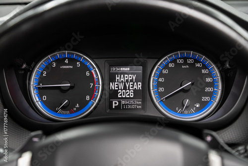 Close up Instrument automobile panel with Odometer, speedometer, tachometer, fuel level, which says Happy New Year 2026. The concept of the new year and Christmas in the automotive field