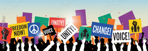 A crowd of diverse people silhouette holding up signs with messages like UNITY!, FREEDOM NOW!, VOICE!, and CHANGE! at a political protest or rally.