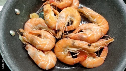 Chef frying king prawns in a pan