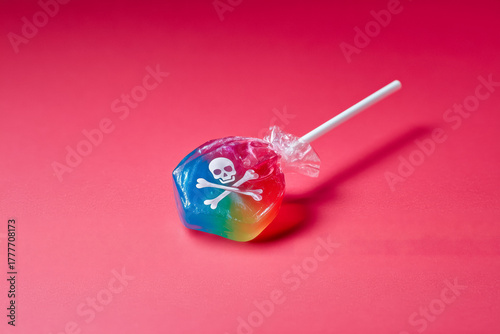 Vibrant rainbow lollipop with skull and crossbones warning, a sweet treat with a dangerous twist for conceptual marketing