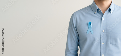 Men health awareness blue ribbon on mans shirt for mens health, concept with copy space