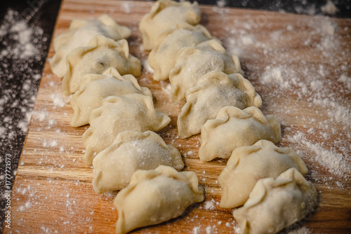 Canvastavla Homemade raw dumplings on floured wooden surface