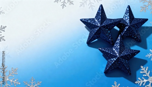 Christmas holiday decorations with blue glitter stars and silver snowflakes. Festive winter flat lay on a gradient background. Copy space for text