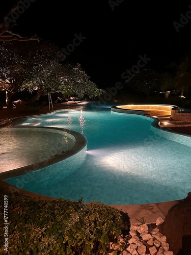 outdoor swimming pool decorated with light at night time