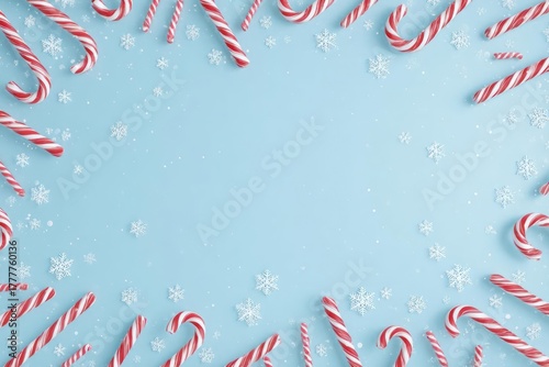 Festive frame of red and white striped candy canes scattered on a light blue background with subtle snowflake accents