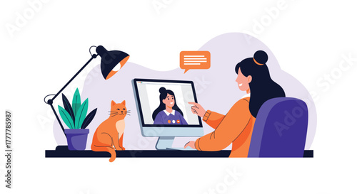 Young woman having a pleasant video call on her computer in a cozy home office, accompanied by her cute orange cat on the desk.