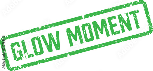 A vivid green rectangular rubber stamp featuring the textured words GLOW MOMENT