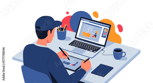 Illustrator at Work: A Digital Artist Creating Visuals on His Laptop and Drawing Tablet