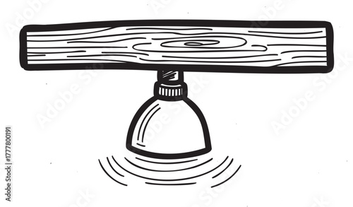Black outline illustration of a wooden plank balanced on a round base, resembling a simple seesaw or equilibrium toy.