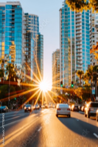 Urban city street with high-rise buildings and cars at sunset, blurred lights and golden sun rays