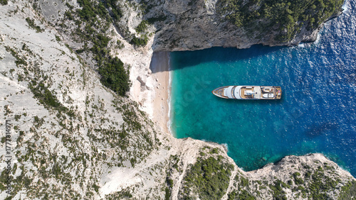 Aerial drone ultra wide panoramic top down photo with copy space of luxury yacht anchored in tropical exotic island with crystal clear turquoise sea