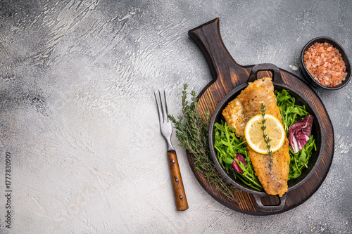 Canvastavla Fried Haddock fish fillet in a pan. grey background. top view