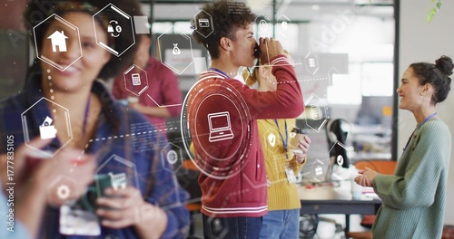 Drinking coworker in red sweater holding coffee mug at office break area, with digital icons