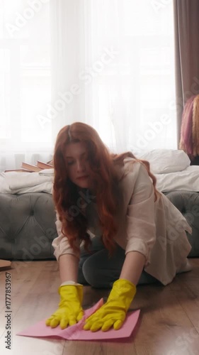Caucasian woman at home cleaning washing floor wiping dust with napkin sitting in knees in bedroom female girl busy with housekeeping duties chores housework routine cleanup house wipe wet rag mopping