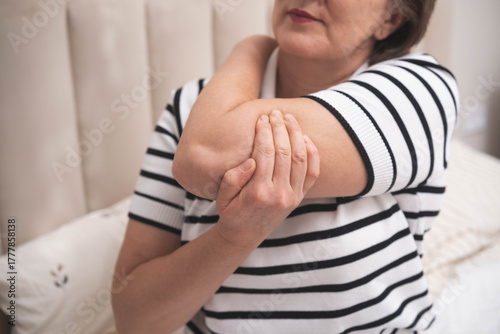 Fototapeta Muscle aches. Adult woman has pain in arm muscles.