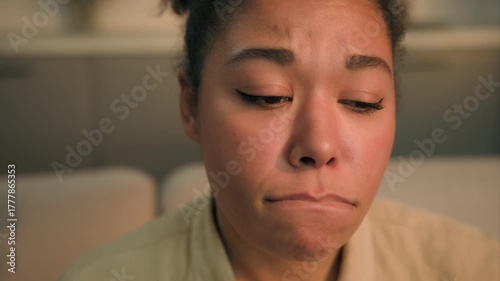 Pensive sad African American woman disappointed thinking problem at home upset lady thoughtful frustrated sorrowful girl female chronic depression lonely grief breakup health trouble pondering indoors