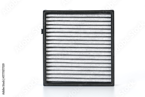The replaced car air filter displays a clear difference between the cleaner air outlet side and the dirty intake side, showing how the filter effectively captures dust and debris.