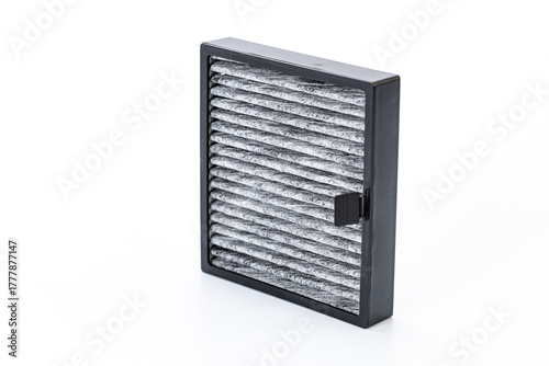 The replaced car air filter reveals a clear difference between the dirty, dust-covered air intake side and the cleaner air outlet side, showing how it traps impurities.