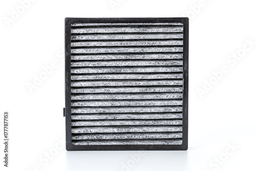 The replaced car air filter reveals a clear difference between the dirty, dust-covered air intake side and the cleaner air outlet side, showing how it traps impurities.