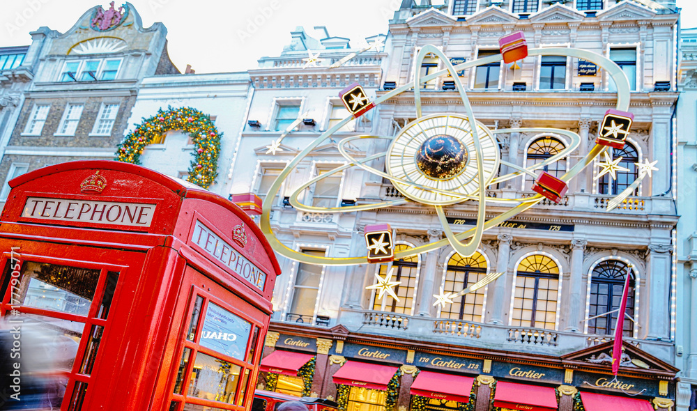 Obraz premium Christmas Decorations, Cartier Boutique Shop, Old Bond Street, Red Telephone Box, Festive Celebration, West End, Central London, England, UK - December 2024