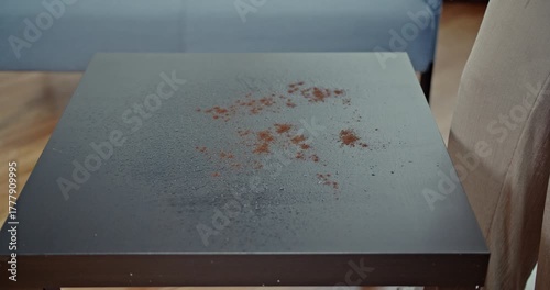 Satisfying process of cleaning a coffee spill off a dark table, with every spray and wipe captured in clear, immersive sound. This video highlights domestic chores and effective cleaning methods.